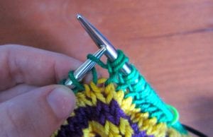 Here you can see the second loop of one stitch (the first loop on the left needle) and the first loop of the following stitch (the loop just above my thumb).