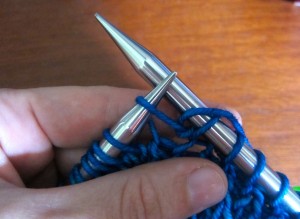 K1 into the stitch, but do not take it off the left needle. Wrap the yarn around the right needle (yo).