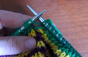 Now, knit the second loop of the last stitch together with the first loop of the first stitch of the new round.