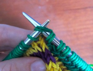 This is how it looks to knit the second loop and following first loop together.