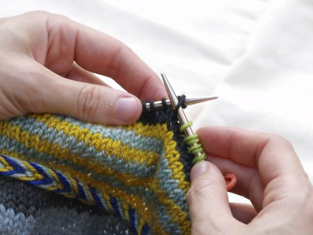 Slip purlwise: Just put the right needle in like you're going to purl the stitch. Then, slip the stitch from the left needle to the right needle.
