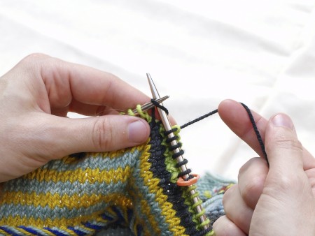 When you're done with the contrast color rounds, knit all the stitches with the main color.
