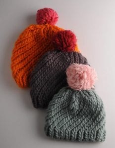 This Swirly Hat knit project can be made with just on skein - including the pom pom! If you want a contrast pom, two skeins will net you two hats. One for you and one for a gift!