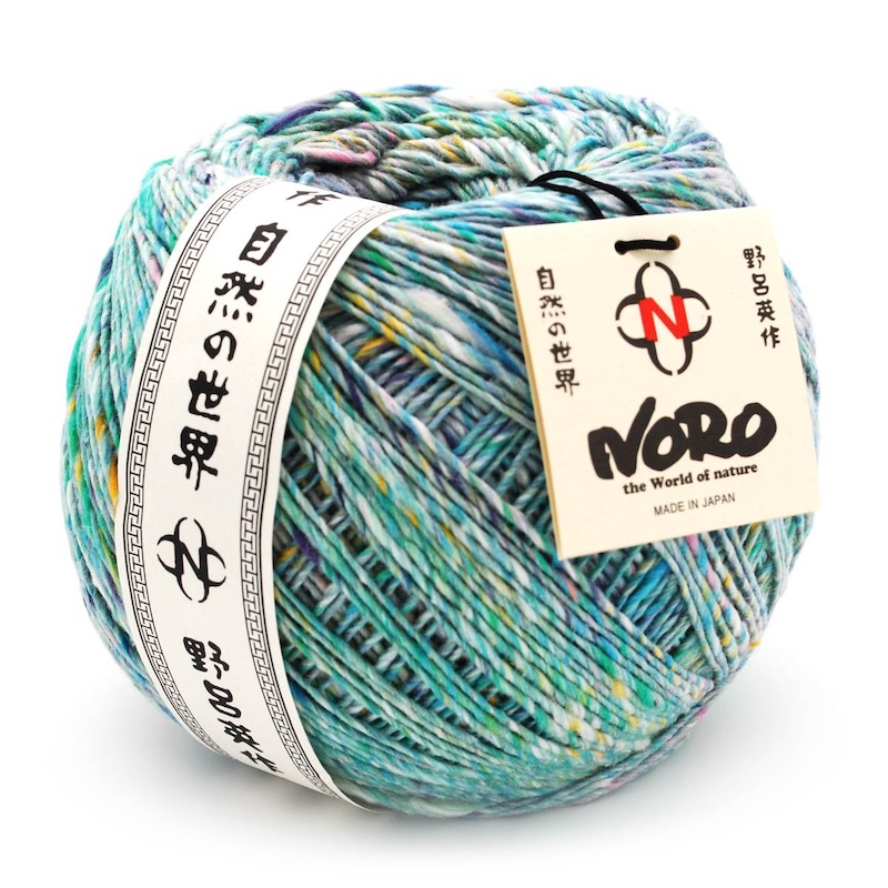 A ball of multicolored cotton and silk yarn with paper labels
