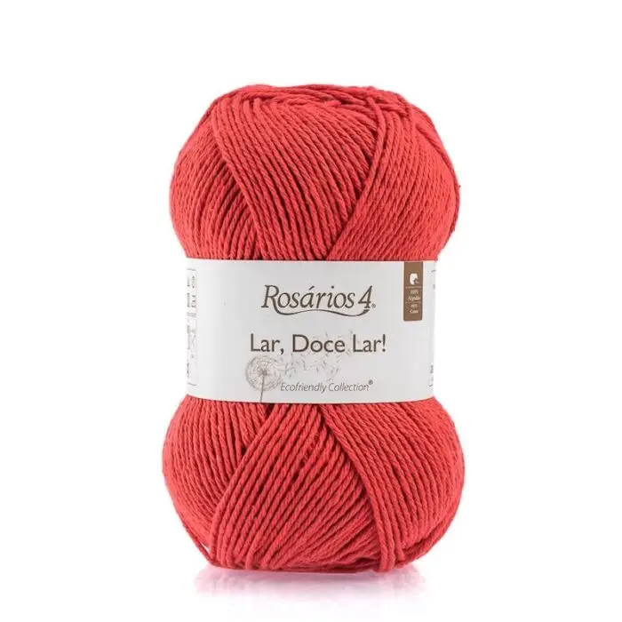 A skein of red cotton yarn with a white paper label.