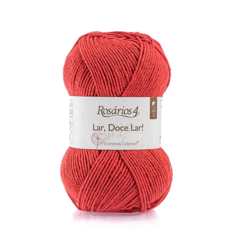 A skein of red cotton yarn with a white paper label.