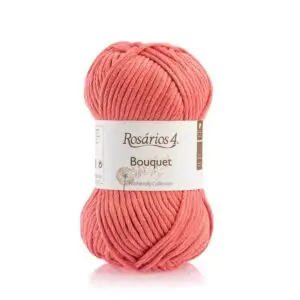 A skein of Rosários 4 Bouquet yarn in bright coral.
