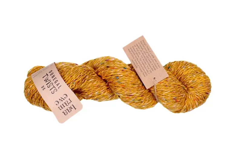 A skein of Baa Ram Ewe Donegal Twists yarn in warm yellow.