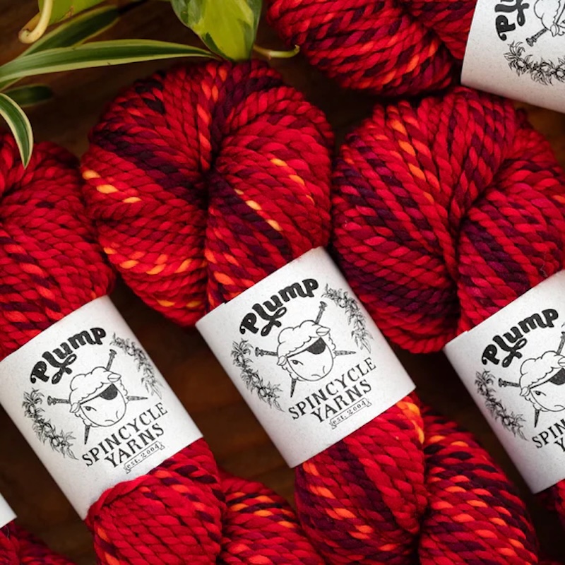 Marled skeins of Spincycle Yarns Plump yarn in fiery red shades.