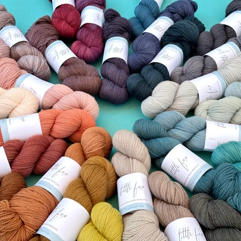 Piled skeins of Little Fox Yarn TrueWash Fine.