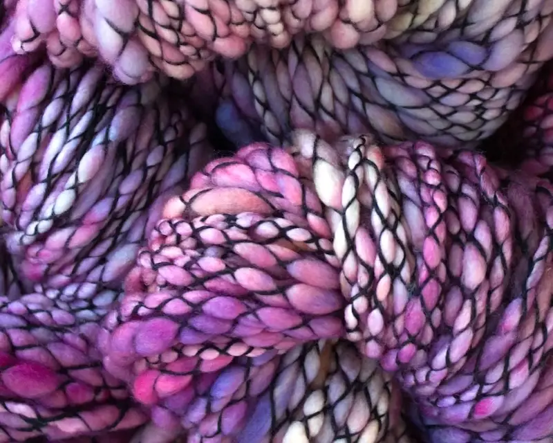 Closeup of Malabrigo Caracol yarn in variegated shades of purple