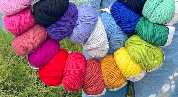 Balls of Fonty Felletin yarn strung in rainbow order
