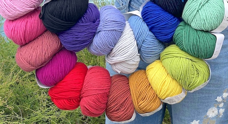 Balls of Fonty Felletin yarn strung in rainbow order